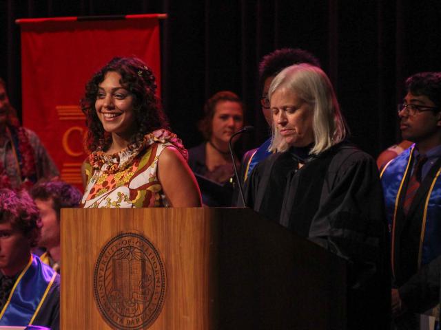 Leila Youssefi (left) smiles while Interim Dean Kathy Foltz (right) reads her accolades and future plans. Photo: Will Proctor